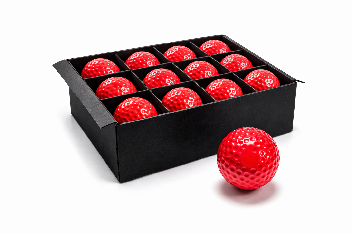 Red golf balls in a black box on a white background