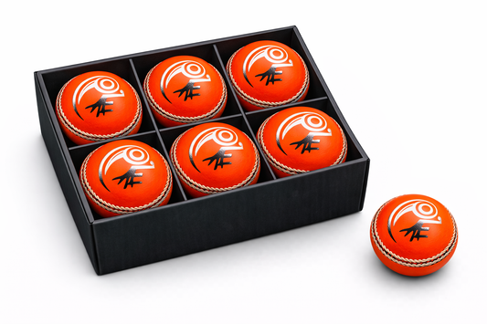 Orange cricket balls with black patterns in a black box on a white background